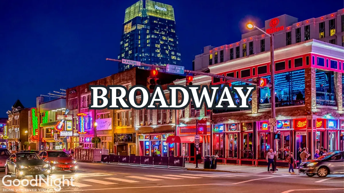 A bustling streetscape featuring bright neon signs, colorful buildings, and people walking along a lively street—evoking the energy of Nashville's nightlife and live music scene.